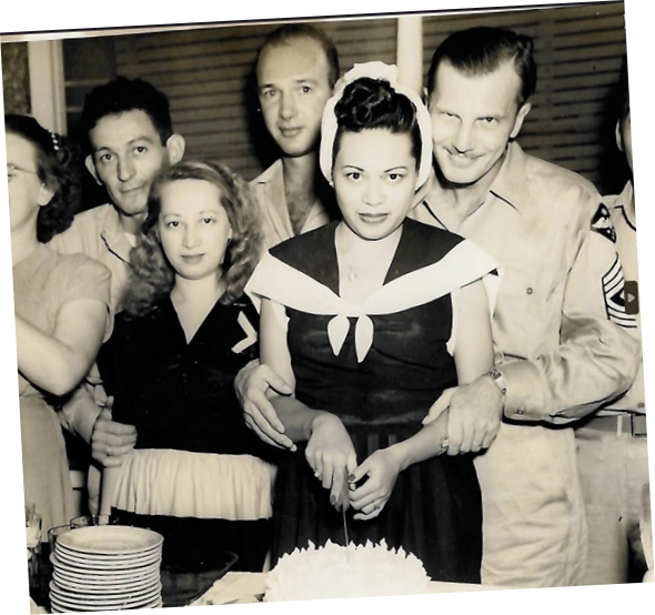 Group of people celebrating Cora Anniversary cake cutting